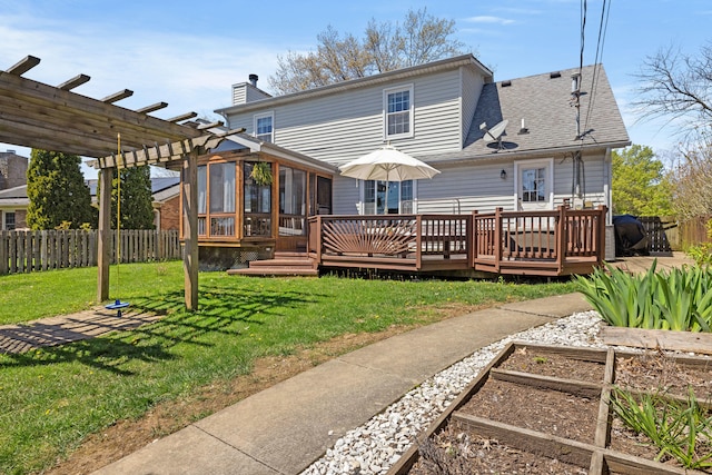 back of property with a pergola, fence, a sunroom, and a deck
