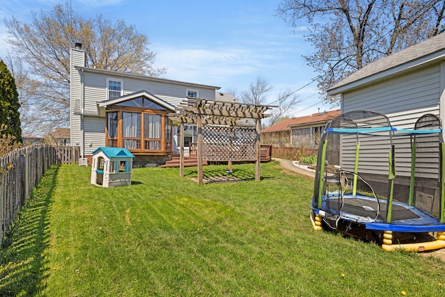 rear view of property featuring a fenced backyard, a trampoline, a pergola, and a chimney