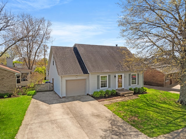 view of front of home with fence, a front lawn, concrete driveway, an attached garage, and a shingled roof
