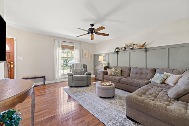 living area with a ceiling fan and wood finished floors