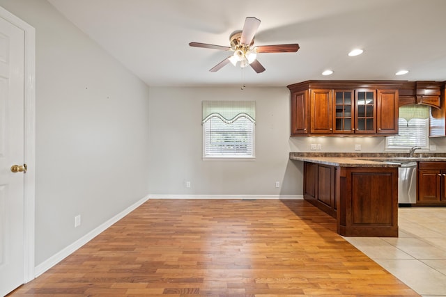 307 N Doctor St, Springfield, KY 40069 - kitchen featuring light wood-style floors, a ceiling fan, a wealth of natural light, and glass insert cabinets