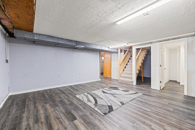 307 N Doctor St, Springfield, KY 40069 - finished below grade area with a textured ceiling, stairway, wood finished floors, and baseboards