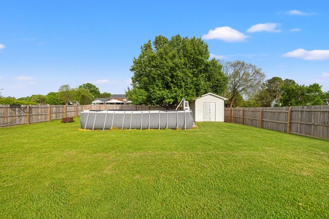 307 N Doctor St, Springfield, KY 40069 - view of yard featuring an outdoor structure, a fenced in pool, a storage unit, and a fenced backyard