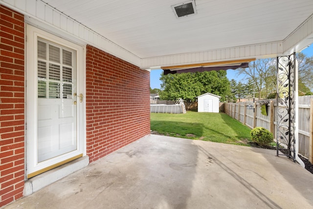 307 N Doctor St, Springfield, KY 40069 - view of patio / terrace with an outdoor structure, a fenced backyard, and a storage shed