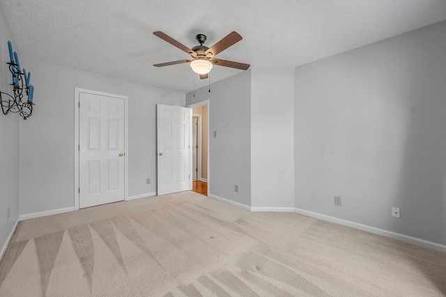 unfurnished bedroom featuring a textured ceiling, baseboards, and carpet floors
