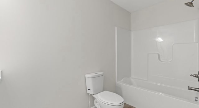 bathroom featuring toilet and bathing tub / shower combination
