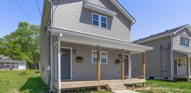 view of front of house with a front yard, crawl space, and covered porch