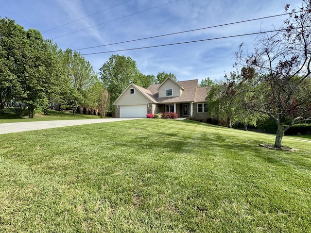 view of front of house featuring concrete driveway, a front yard, and a garage