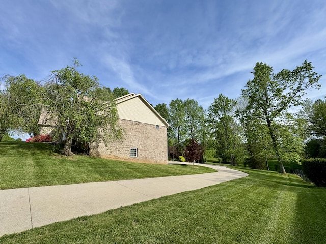 view of home's exterior featuring a yard and brick siding