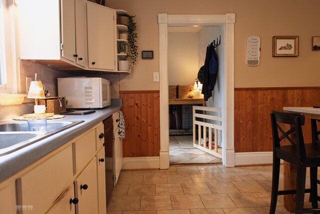 1770 Millersburg-Cynthiana Rd, Paris, KY 40361 - kitchen featuring open shelves, a wainscoted wall, white microwave, wood walls, and white cabinets