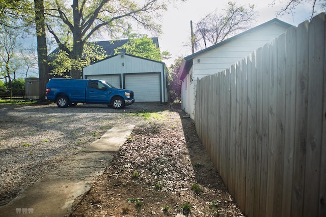 1770 Millersburg-Cynthiana Rd, Paris, KY 40361 - view of yard featuring an outbuilding, a detached garage, dirt driveway, and fence