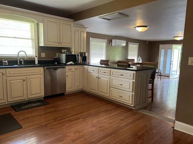 513 Sharp Gap Rd, Barbourville, KY 40906 - kitchen featuring a sink, stainless steel appliances, cream cabinetry, an AC wall unit, and a peninsula