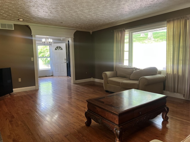 513 Sharp Gap Rd, Barbourville, KY 40906 - living room with an inviting chandelier, visible vents, plenty of natural light, and crown molding