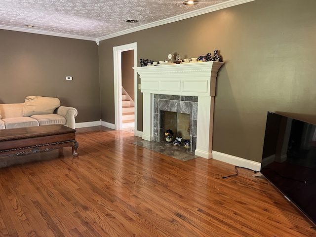 513 Sharp Gap Rd, Barbourville, KY 40906 - living room featuring baseboards, wood finished floors, ornamental molding, and a fireplace