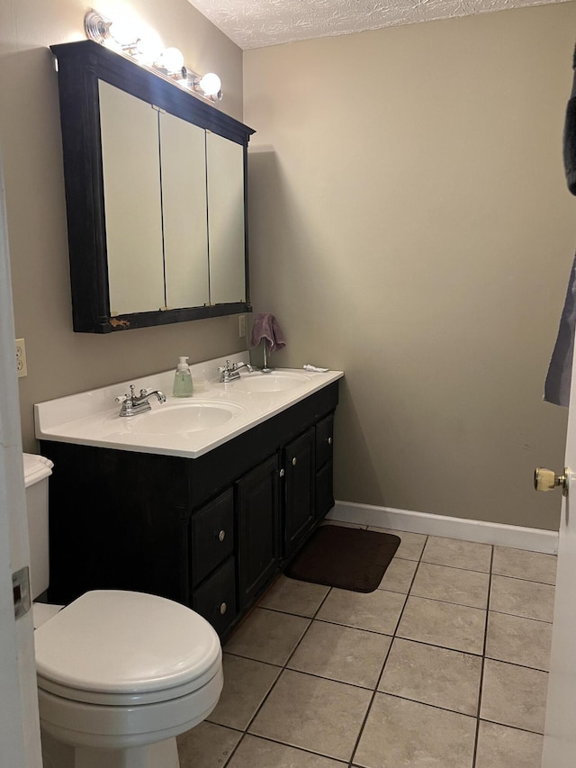 513 Sharp Gap Rd, Barbourville, KY 40906 - bathroom with double vanity, a textured ceiling, tile patterned flooring, and a sink