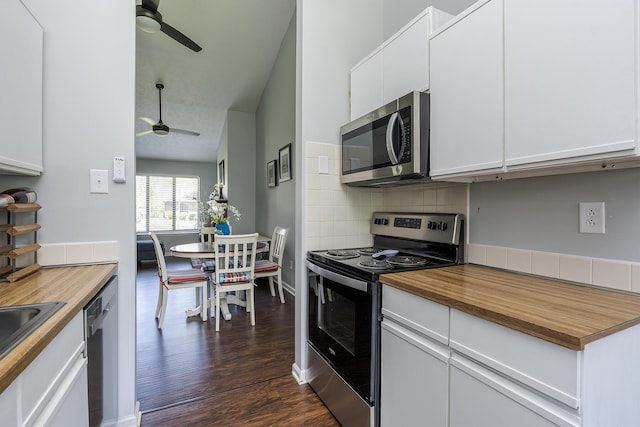 kitchen with stainless steel appliances, ceiling fan, dark wood-type flooring, backsplash, and butcher block counters