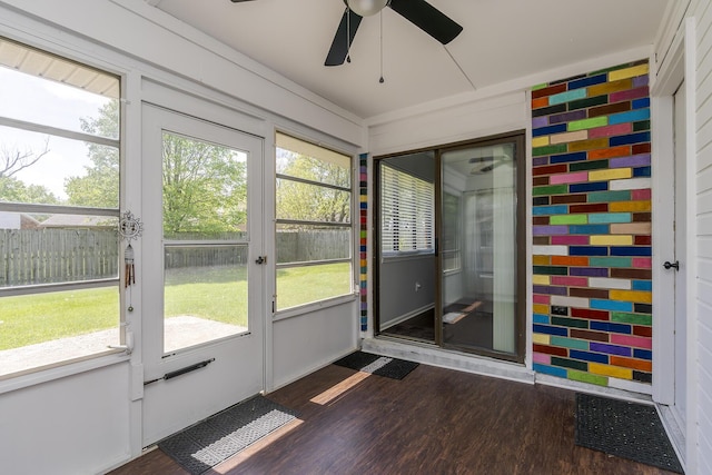 unfurnished sunroom with a wealth of natural light and ceiling fan