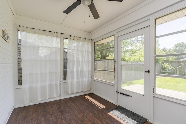 unfurnished sunroom featuring a healthy amount of sunlight and ceiling fan