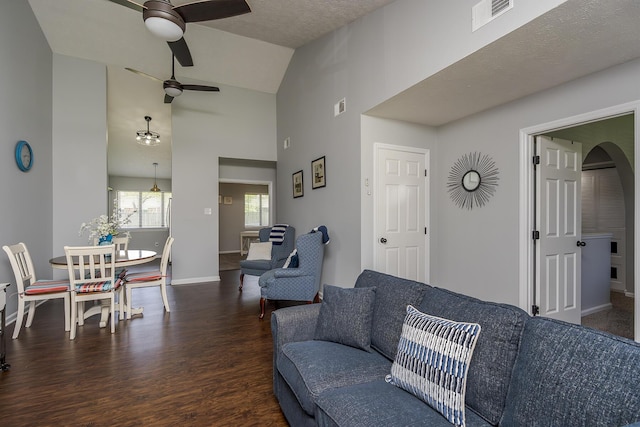 living area featuring wood finished floors, visible vents, ceiling fan, and baseboards