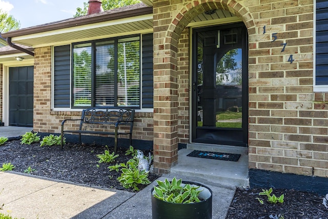 view of exterior entry with brick siding