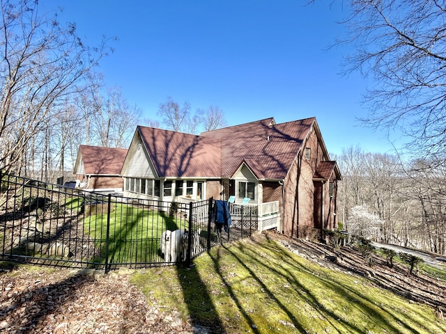 rear view of property featuring a lawn, a gate, and a fenced front yard