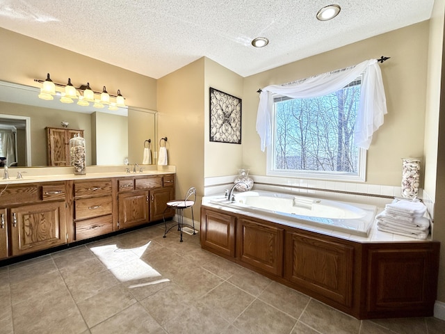 full bathroom with a textured ceiling, a garden tub, and a sink