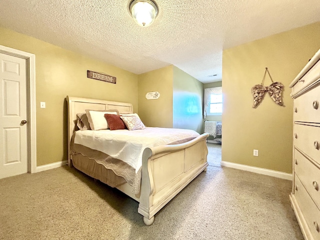 bedroom with a textured ceiling and baseboards