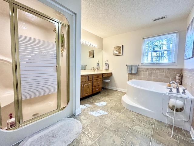 bathroom with a textured ceiling, visible vents, a stall shower, tile patterned floors, and a garden tub