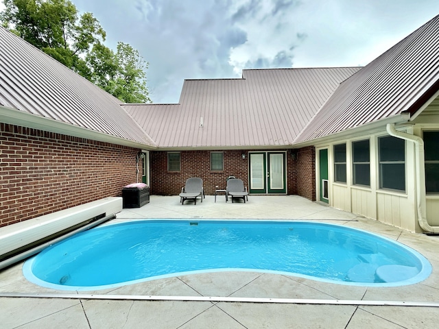 outdoor pool with a patio area