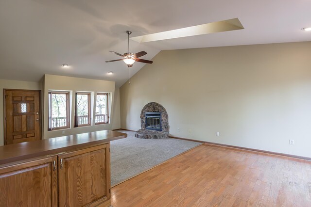 420 Stonehedge Pl, Lexington, KY 40517 - unfurnished living room with a stone fireplace, baseboards, ceiling fan, and vaulted ceiling
