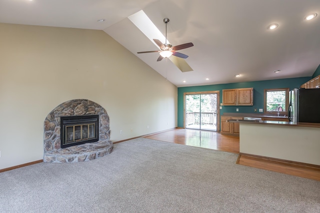 420 Stonehedge Pl, Lexington, KY 40517 - unfurnished living room featuring light colored carpet, baseboards, ceiling fan, and a healthy amount of sunlight