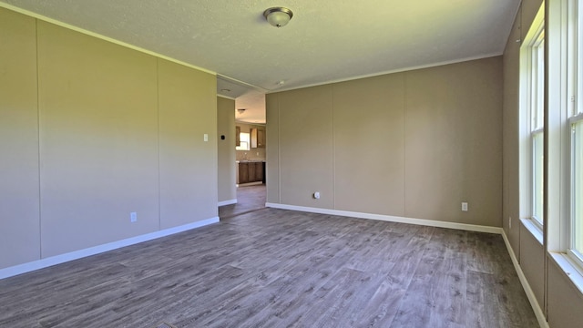 empty room with wood finished floors and baseboards