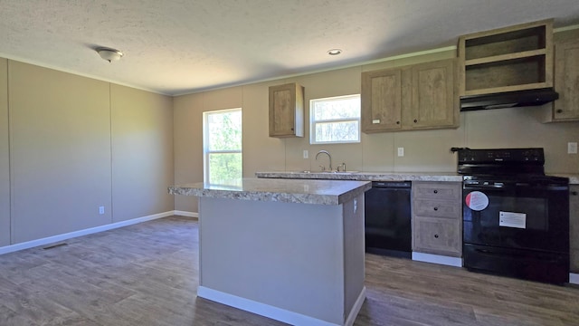 kitchen featuring a sink, under cabinet range hood, black appliances, a kitchen island, and dark wood finished floors