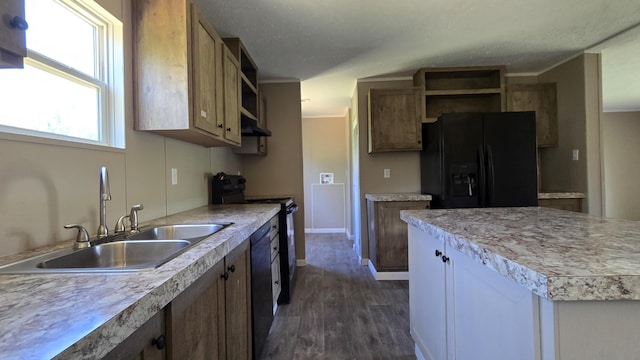 kitchen featuring open shelves, a sink, under cabinet range hood, black appliances, and dark wood-type flooring