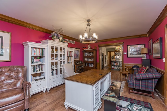 home office with visible vents, ornamental molding, wood finished floors, and a notable chandelier