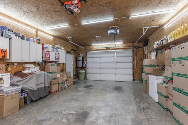 garage with water heater, refrigerator, and a garage door opener