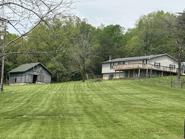 91 Barnett Rd, Brodhead, KY 40409 - view of yard featuring a deck, a barn, a view of trees, and an outbuilding