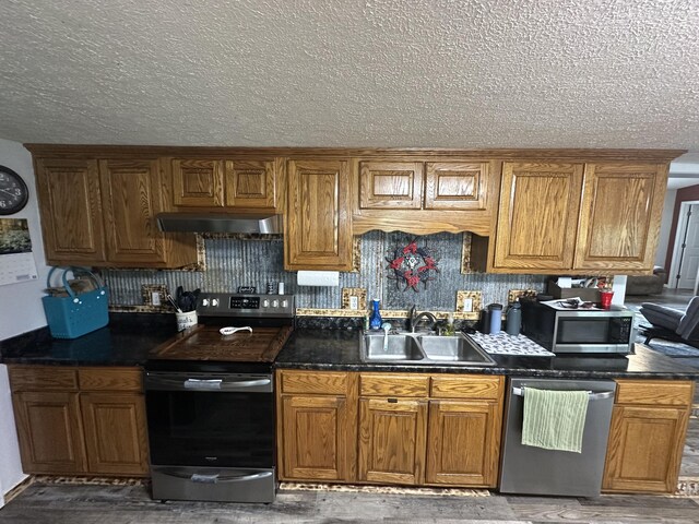 91 Barnett Rd, Brodhead, KY 40409 - kitchen with brown cabinetry, stainless steel appliances, dark countertops, and a sink