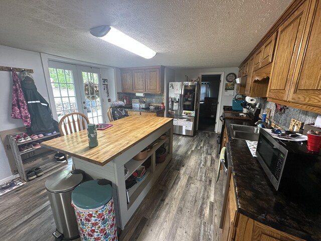 91 Barnett Rd, Brodhead, KY 40409 - kitchen with stainless steel appliances, brown cabinetry, dark wood-type flooring, a textured ceiling, and butcher block counters