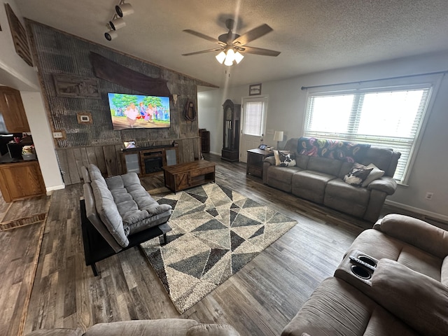 91 Barnett Rd, Brodhead, KY 40409 - living area featuring track lighting, wood finished floors, ceiling fan, a fireplace, and baseboards