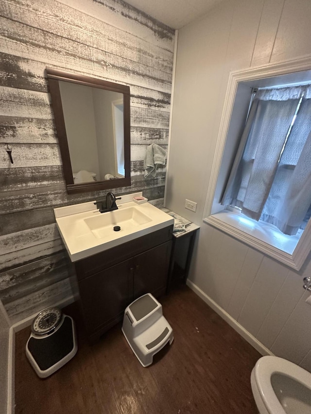 91 Barnett Rd, Brodhead, KY 40409 - bathroom with wood walls, wood finished floors, toilet, and vanity