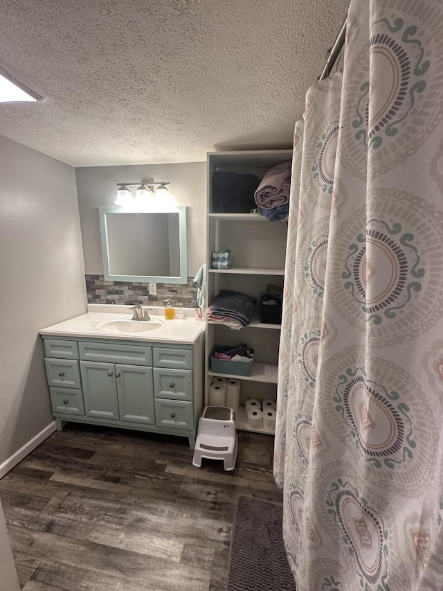 91 Barnett Rd, Brodhead, KY 40409 - full bathroom with a textured ceiling, wood finished floors, vanity, and decorative backsplash