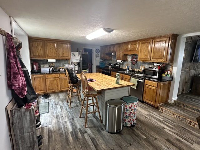 91 Barnett Rd, Brodhead, KY 40409 - kitchen with tasteful backsplash, wooden counters, dark wood-style flooring, and appliances with stainless steel finishes