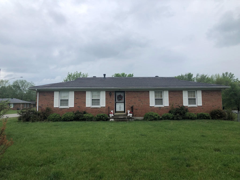 single story home with brick siding and a front lawn