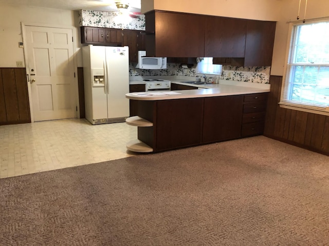 98 Lois St, Lawrenceburg, KY 40342 - kitchen featuring white appliances, a peninsula, dark brown cabinetry, light colored carpet, and light countertops