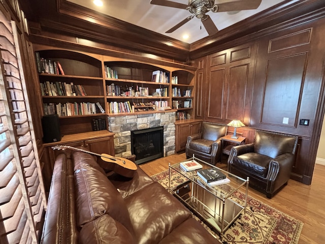 sitting room with crown molding, a ceiling fan, and light wood-style floors
