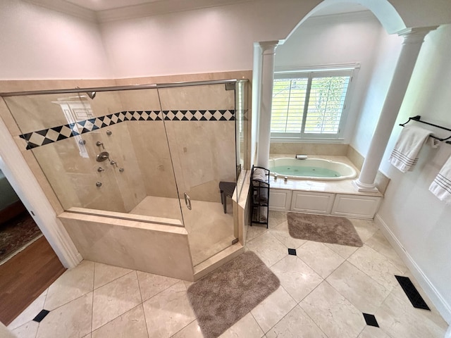 bathroom with ornate columns, visible vents, crown molding, and a garden tub