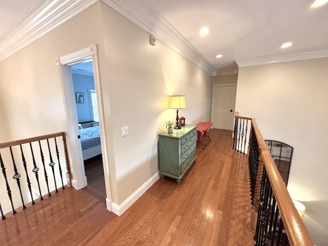 hallway featuring crown molding, an upstairs landing, baseboards, recessed lighting, and wood finished floors