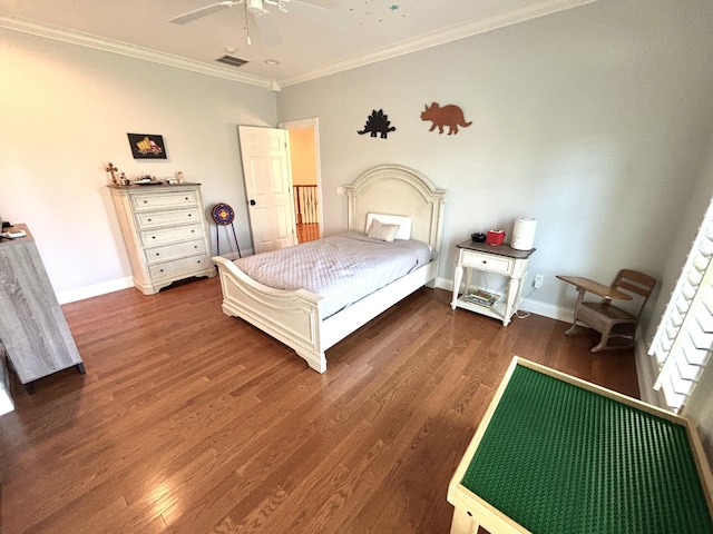 bedroom featuring wood finished floors, visible vents, ornamental molding, and baseboards
