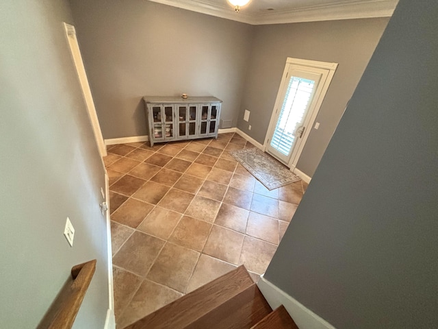 interior space with crown molding and baseboards